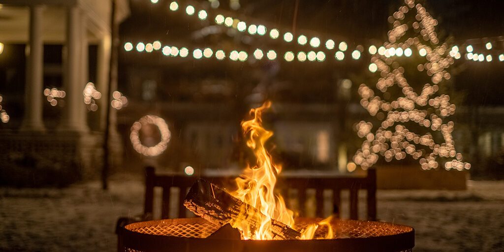 Christmas lights adorn trees surrounding the Firepit at Langdon Hall